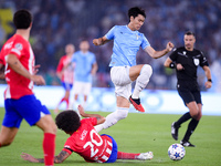 Daichi Kamada of SS Lazio and Axel Witsel of Atletico de Madrid compete for the ball during the UEFA Champions League Group E match between...