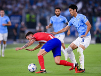 Saul Niguez of Atletico de Madrid and Daichi Kamada of SS Lazio compete for the ball during the UEFA Champions League Group E match between...