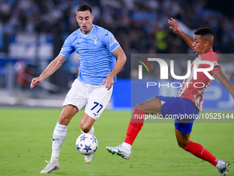 Adam Marusic of SS Lazio and Samuel Lino of Atletico de Madrid compete for the ball during the UEFA Champions League Group E match between S...