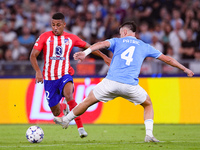 Samuel Lino of Atletico de Madrid and Gil Patric of SS Lazio compete for the ball during the UEFA Champions League Group E match between SS...