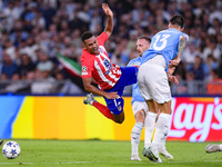 Samuel Lino of Atletico de Madrid and Gil Patric of SS Lazio compete for the ball during the UEFA Champions League Group E match between SS...