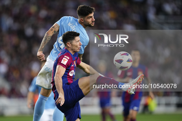 Robert Lewandowski centre-forward of Barcelona and Poland and Unai Nuñez centre-Back of Celta de Vigo and Spain compete for the ball during...