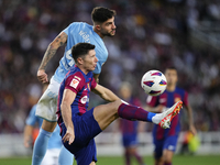 Robert Lewandowski centre-forward of Barcelona and Poland and Unai Nuñez centre-Back of Celta de Vigo and Spain compete for the ball during...