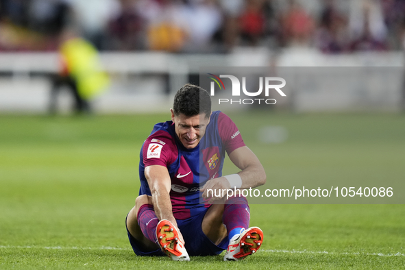 Robert Lewandowski centre-forward of Barcelona and Poland lies injured on the pitch during the LaLiga EA Sports match between FC Barcelona a...