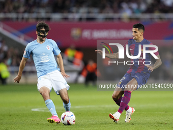 Luca de la Torre central midfield of Celta de Vigo and United States and Joao Cancelo right-back of Barcelona and Portugal compete for the b...