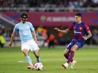 Luca de la Torre central midfield of Celta de Vigo and United States and Joao Cancelo right-back of Barcelona and Portugal compete for the b...