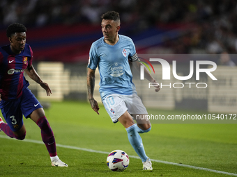 Iago Aspas centre-forward of Celta de Vigo and Spain and Alejandro Balde left-back of Barcelona and Spain compete for the ball during the La...