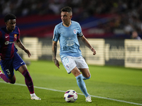 Iago Aspas centre-forward of Celta de Vigo and Spain and Alejandro Balde left-back of Barcelona and Spain compete for the ball during the La...