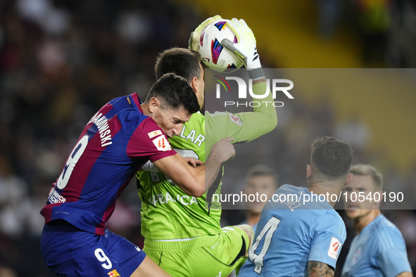 Robert Lewandowski centre-forward of Barcelona and Poland and Ivan Villar goalkeeper of Celta de Vigo and Spain compete for the ball during...