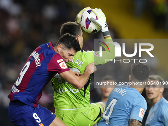 Robert Lewandowski centre-forward of Barcelona and Poland and Ivan Villar goalkeeper of Celta de Vigo and Spain compete for the ball during...