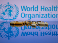 World Health Organization (WHO) displayed on screen with pharmacy close-up of various pills. Seen in this photo illustration, in Brussels, B...