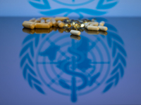 World Health Organization (WHO) displayed on screen with pharmacy close-up of various pills. Seen in this photo illustration, in Brussels, B...