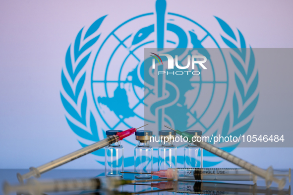 World Health Organization (WHO) displayed on screen with pharmacy medical syringe and vaccine vial. Seen in this photo illustration, in Brus...