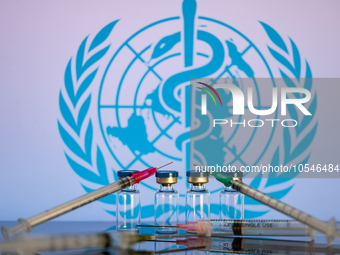 World Health Organization (WHO) displayed on screen with pharmacy medical syringe and vaccine vial. Seen in this photo illustration, in Brus...