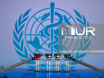 World Health Organization (WHO) displayed on screen with pharmacy medical syringe and vaccine vial. Seen in this photo illustration, in Brus...