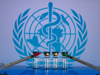 World Health Organization (WHO) displayed on screen with pharmacy medical syringe and vaccine vial. Seen in this photo illustration, in Brus...