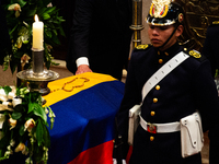 Colombian police and presidential guards guard as the late Colombian artist Fernando Botero lies inside the National Congress during his wak...