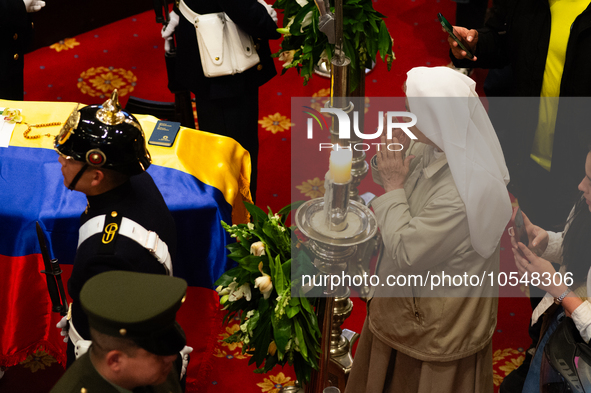 A nun passes near the coffin of the late Colombian artist Fernando Botero lies inside the National Congress during his wake in Bogota, Colom...