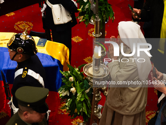 A nun passes near the coffin of the late Colombian artist Fernando Botero lies inside the National Congress during his wake in Bogota, Colom...