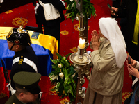 A nun passes near the coffin of the late Colombian artist Fernando Botero lies inside the National Congress during his wake in Bogota, Colom...