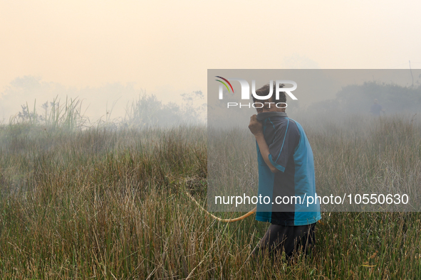 A man in Soak Batok Village, North Indralaya District, Ogan Ilir Regency, South Sumatra is extinguishing forest and land fires on Monday, Se...