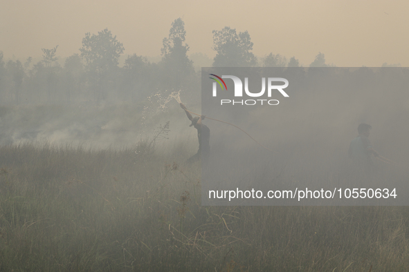 Residents in Soak Batok Village, North Indralaya District, Ogan Ilir Regency, South Sumatra are extinguishing forest and land fires on Monda...