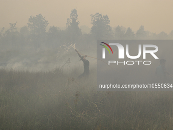 Residents in Soak Batok Village, North Indralaya District, Ogan Ilir Regency, South Sumatra are extinguishing forest and land fires on Monda...