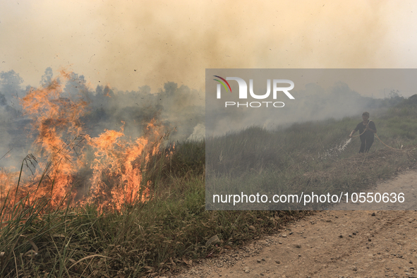 A man in Soak Batok Village, North Indralaya District, Ogan Ilir Regency, South Sumatra are extinguishing forest and land fires on Monday, S...