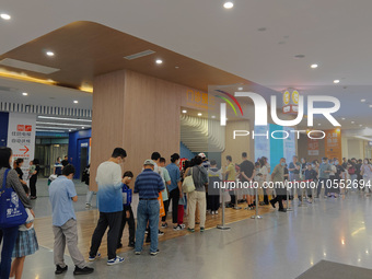 Patients line up for an emergency pre-check at the new pediatric building of Xinhua Hospital in Shanghai, China, On the night of September 2...