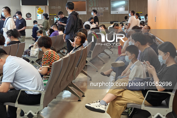 Patients line up for an emergency pre-check at the new pediatric building of Xinhua Hospital in Shanghai, China, On the night of September 2...