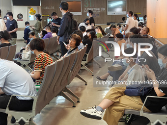 Patients line up for an emergency pre-check at the new pediatric building of Xinhua Hospital in Shanghai, China, On the night of September 2...