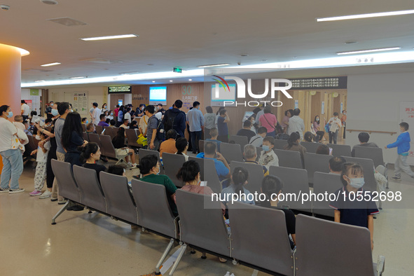 Patients line up for an emergency pre-check at the new pediatric building of Xinhua Hospital in Shanghai, China, On the night of September 2...