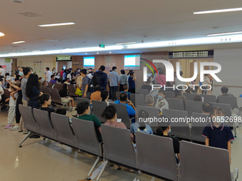 Patients line up for an emergency pre-check at the new pediatric building of Xinhua Hospital in Shanghai, China, On the night of September 2...