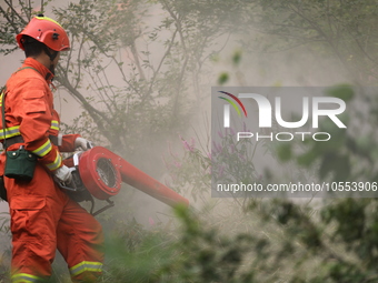 CHENGDE, CHINA - SEPTEMBER 25, 2023 - Firefighters perform a fire fighting drill in a forest area in Chengde, Hebei Province, China, Sept 25...