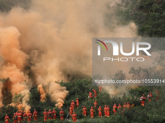 CHENGDE, CHINA - SEPTEMBER 25, 2023 - Firefighters perform a fire fighting drill in a forest area in Chengde, Hebei Province, China, Sept 25...