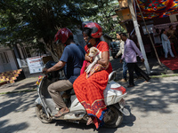 Man and woman returns with their dog on scooter after administer Anti-Rabies Vaccine (ARV) at a Govt. veterinary hospital, during a free ant...