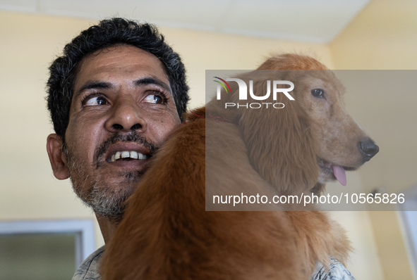 A person with his dog arrives to administere Anti-Rabies Vaccine (ARV) at a Govt. veterinary hospital, during a free anti rabies vaccination...