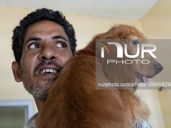 A person with his dog arrives to administere Anti-Rabies Vaccine (ARV) at a Govt. veterinary hospital, during a free anti rabies vaccination...