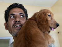 A person with his dog arrives to administere Anti-Rabies Vaccine (ARV) at a Govt. veterinary hospital, during a free anti rabies vaccination...