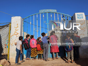 Photos taken on September 30, 2023, show Syrian students attending the first day of the new school year at a makeshift school inside a camp...