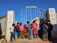 Photos taken on September 30, 2023, show Syrian students attending the first day of the new school year at a makeshift school inside a camp...