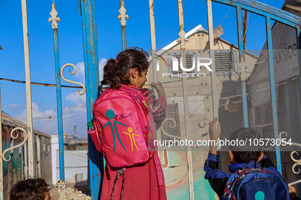 Photos taken on September 30, 2023, show Syrian students attending the first day of the new school year at a makeshift school inside a camp...