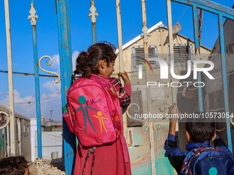 Photos taken on September 30, 2023, show Syrian students attending the first day of the new school year at a makeshift school inside a camp...