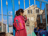 Photos taken on September 30, 2023, show Syrian students attending the first day of the new school year at a makeshift school inside a camp...