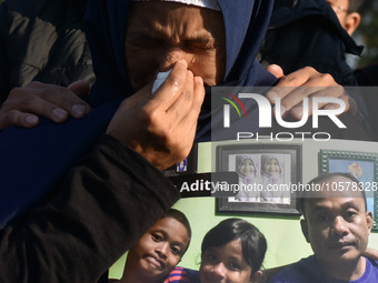 A mother cries
carrying  the photos of victim tragedy,  during praying to commemorate the 1st anniversary of the Kanjuruhan tragedy which 1...