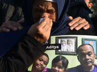 A mother cries
carrying  the photos of victim tragedy,  during praying to commemorate the 1st anniversary of the Kanjuruhan tragedy which 1...