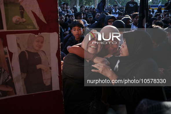 Family members of a tragedy victim are becoming hysterical at the 13th gate of the stadium during a prayer commemorating the first anniversa...