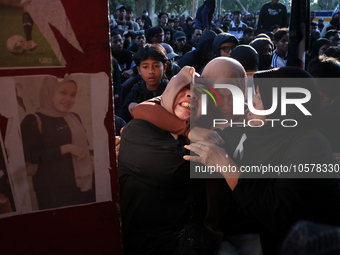 Family members of a tragedy victim are becoming hysterical at the 13th gate of the stadium during a prayer commemorating the first anniversa...