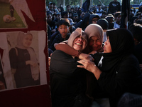 Family members of a tragedy victim are becoming hysterical at the 13th gate of the stadium during a prayer commemorating the first anniversa...