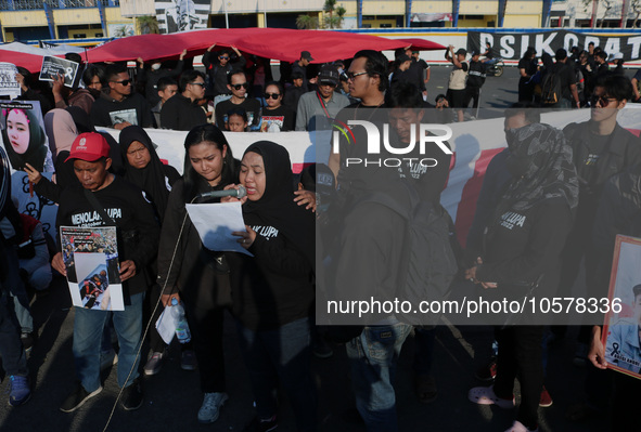 Hundreds of family members of tragedy victims read demands for legal justice to the Indonesian government in front of the stadium, during co...